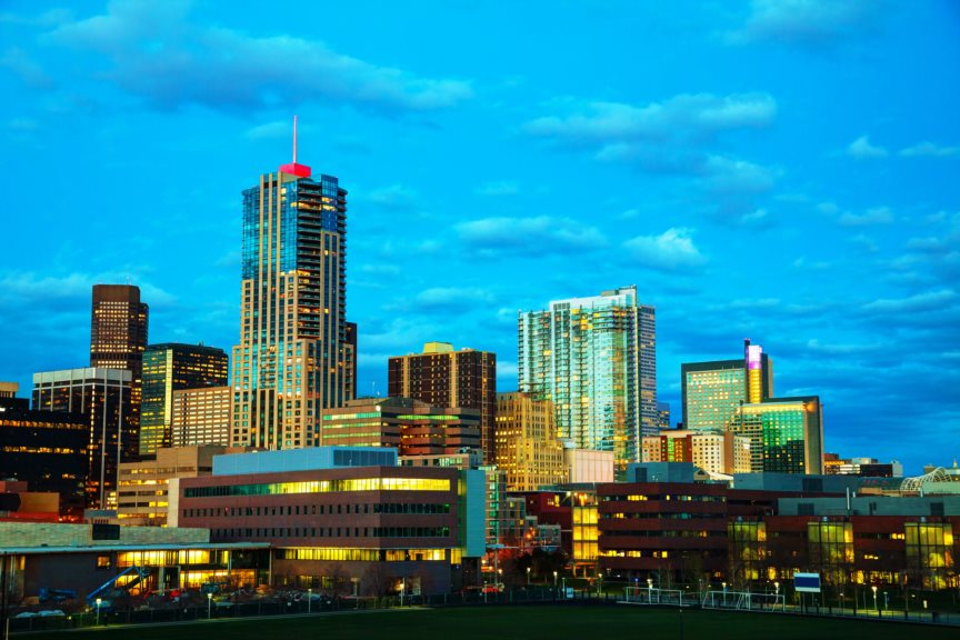 Cities With the Hardest-Working Parents - Denver skyline against bright blue sky.