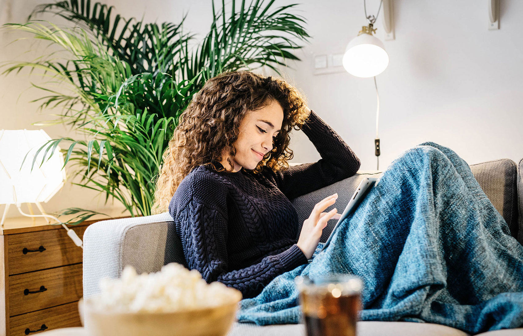 how to write a last will and testament - woman on a couch using an iPad