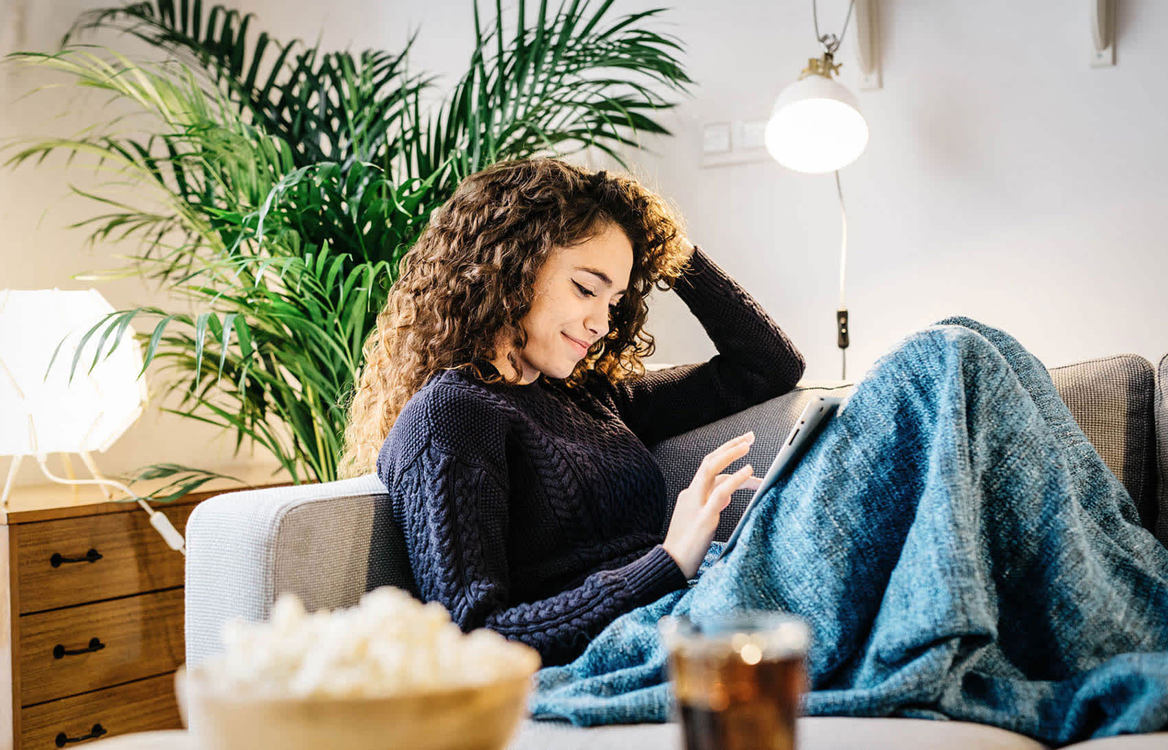 how to write a last will and testament - woman on a couch using an iPad