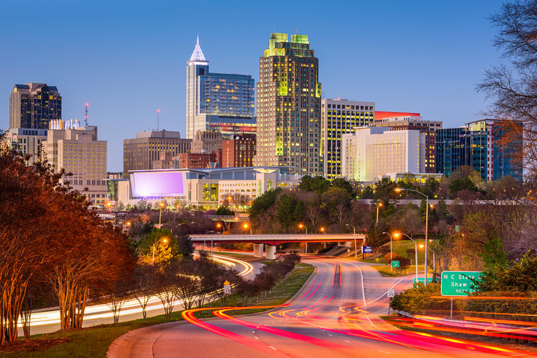 10 Best Cities in America for Single Parents - Downtown skyline of Raleigh, NC during evening rush hour. 