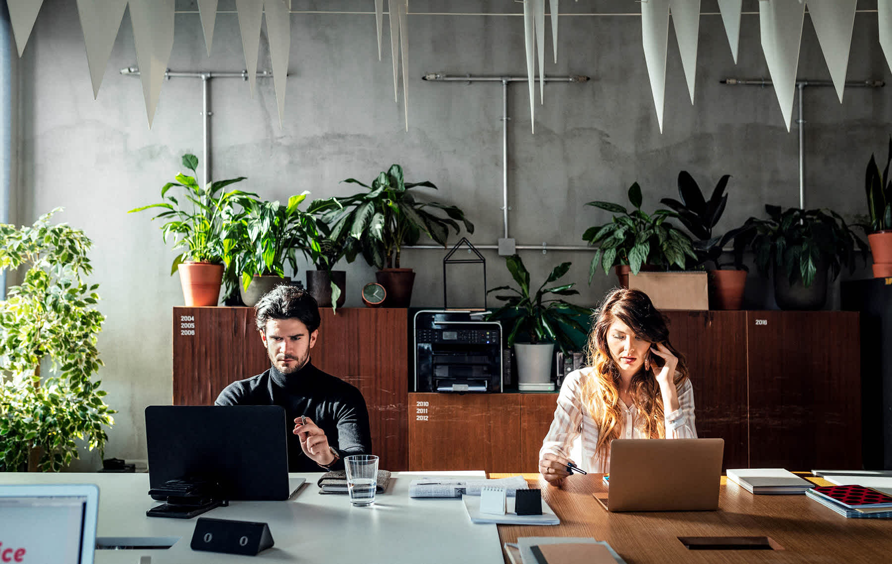 is my group life insurance plan enough? - man and woman on laptops in stylish office