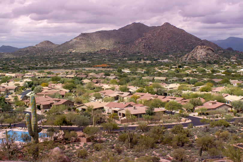 The Healthiest Cities in the United States for Families - Desert in Scottsdale, AZ with homes scattered in front of a mountain. 