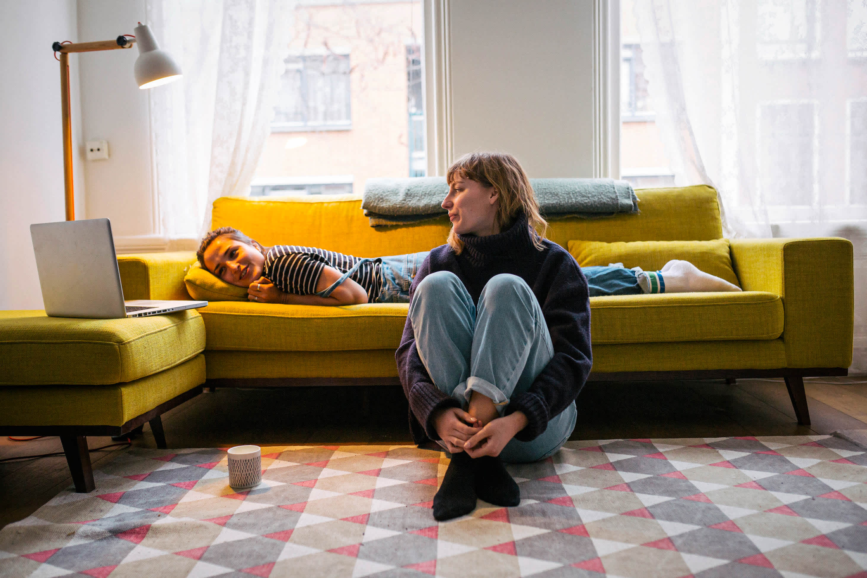 life insurance myths - two women talking in a living room near a laptop