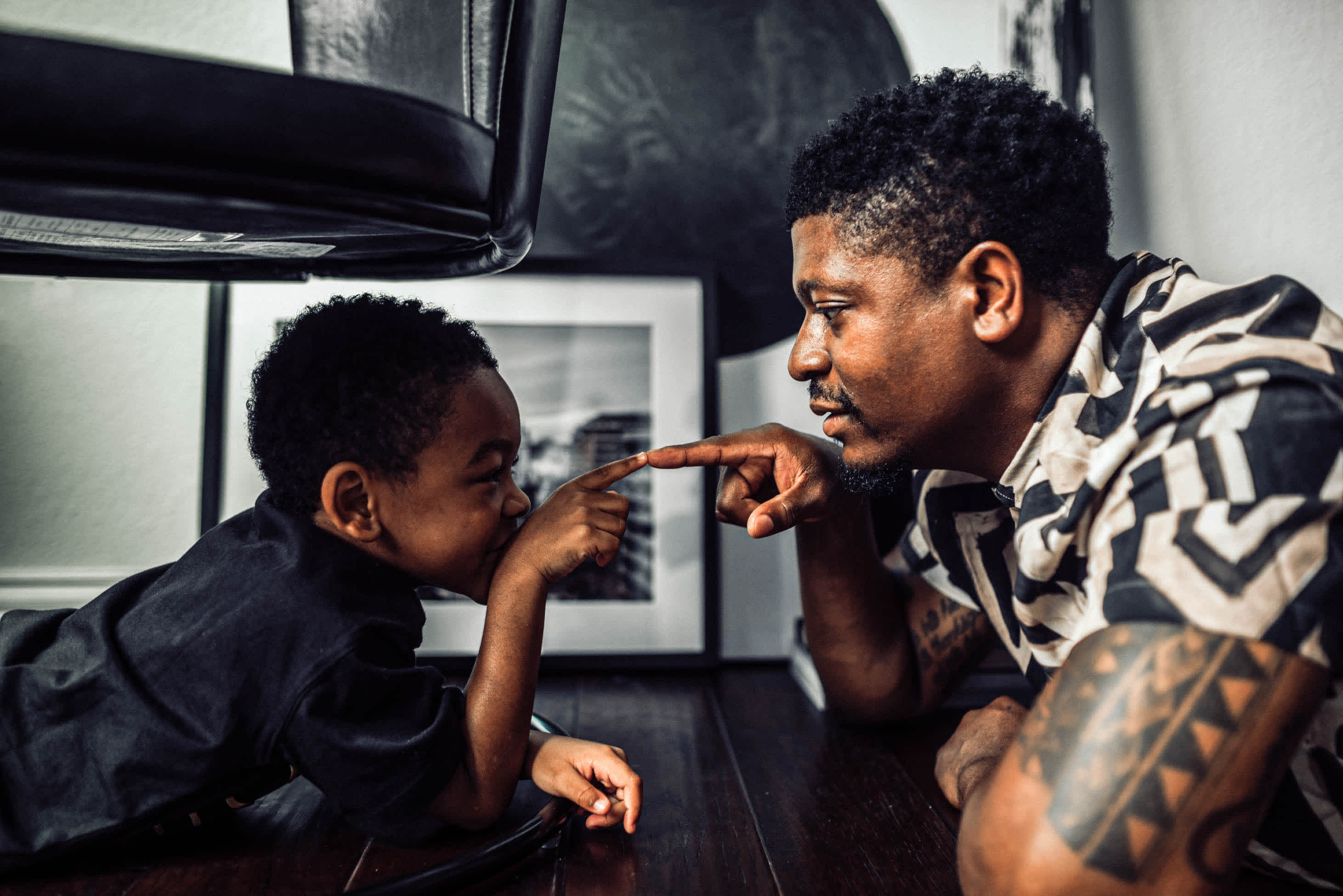 father and son playing and pointing at each other - who actually needs a $1 million life insurance policy