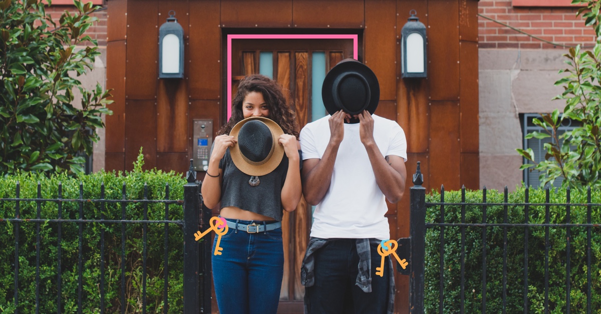 man and woman playing with fedoras in front of a house - tips for buying your first home