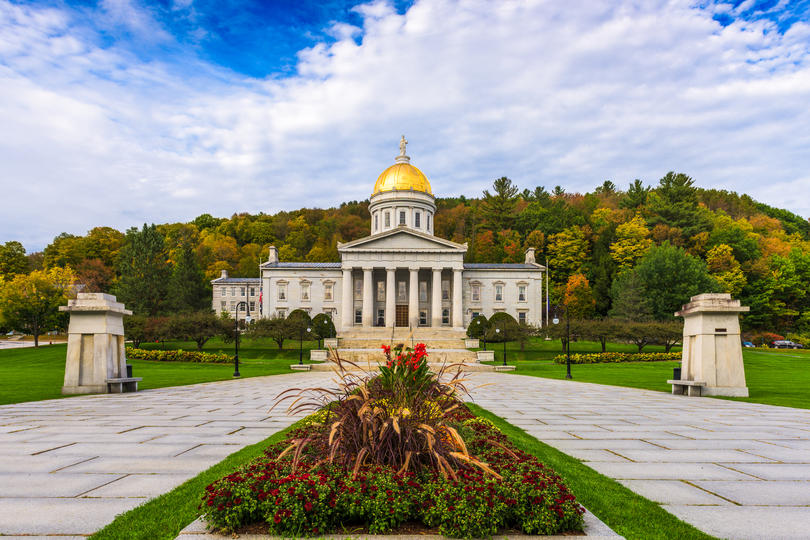 States with the best public schools - capitol building in Montpelier, Vermont surrounded by a lush forest.