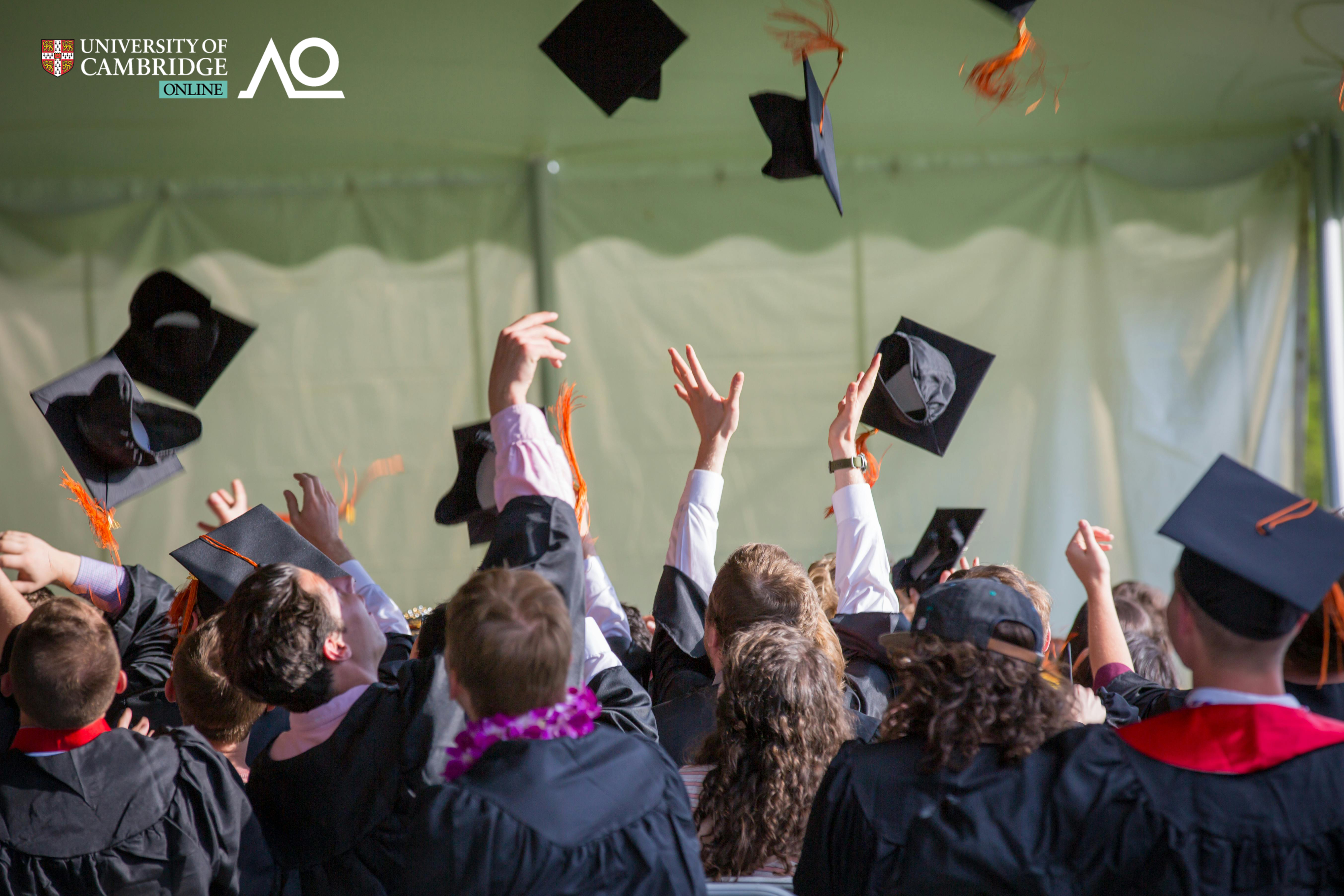 Back-view of graduates throwing their mortarboards in the air.