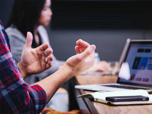 A man's hands gesturing as he explains a concept