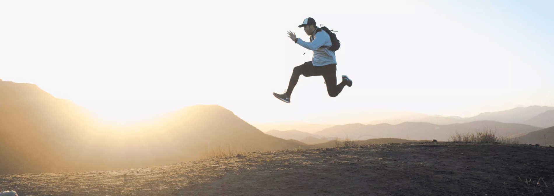 Man in baseball cap leading in the air