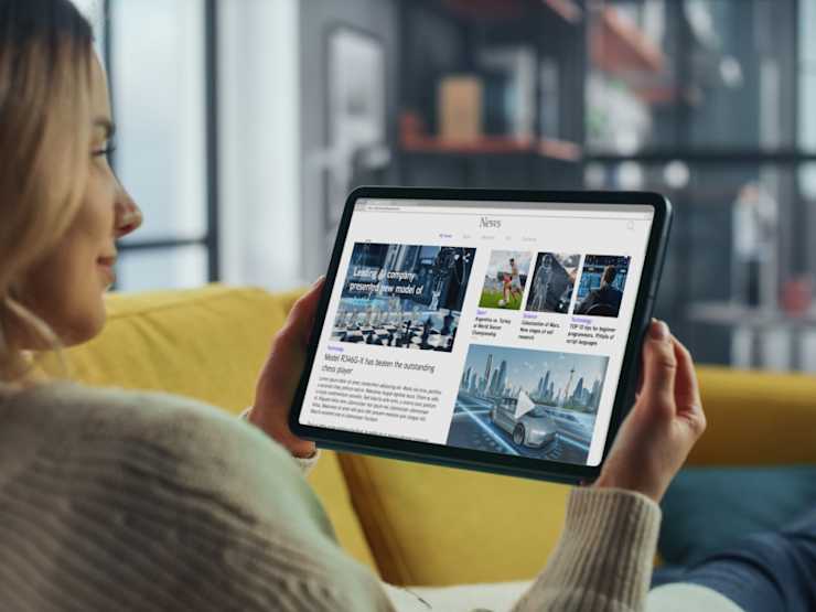 A woman reading news on tablet.