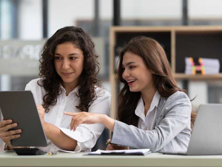 Two woman discussion over a tablet