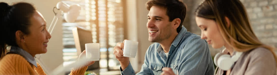 Colleagues having coffee in office