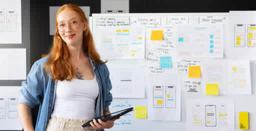 A woman standing in front of drawing board