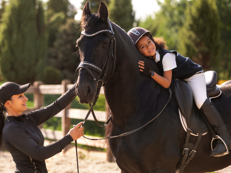 A child and woman with a horse