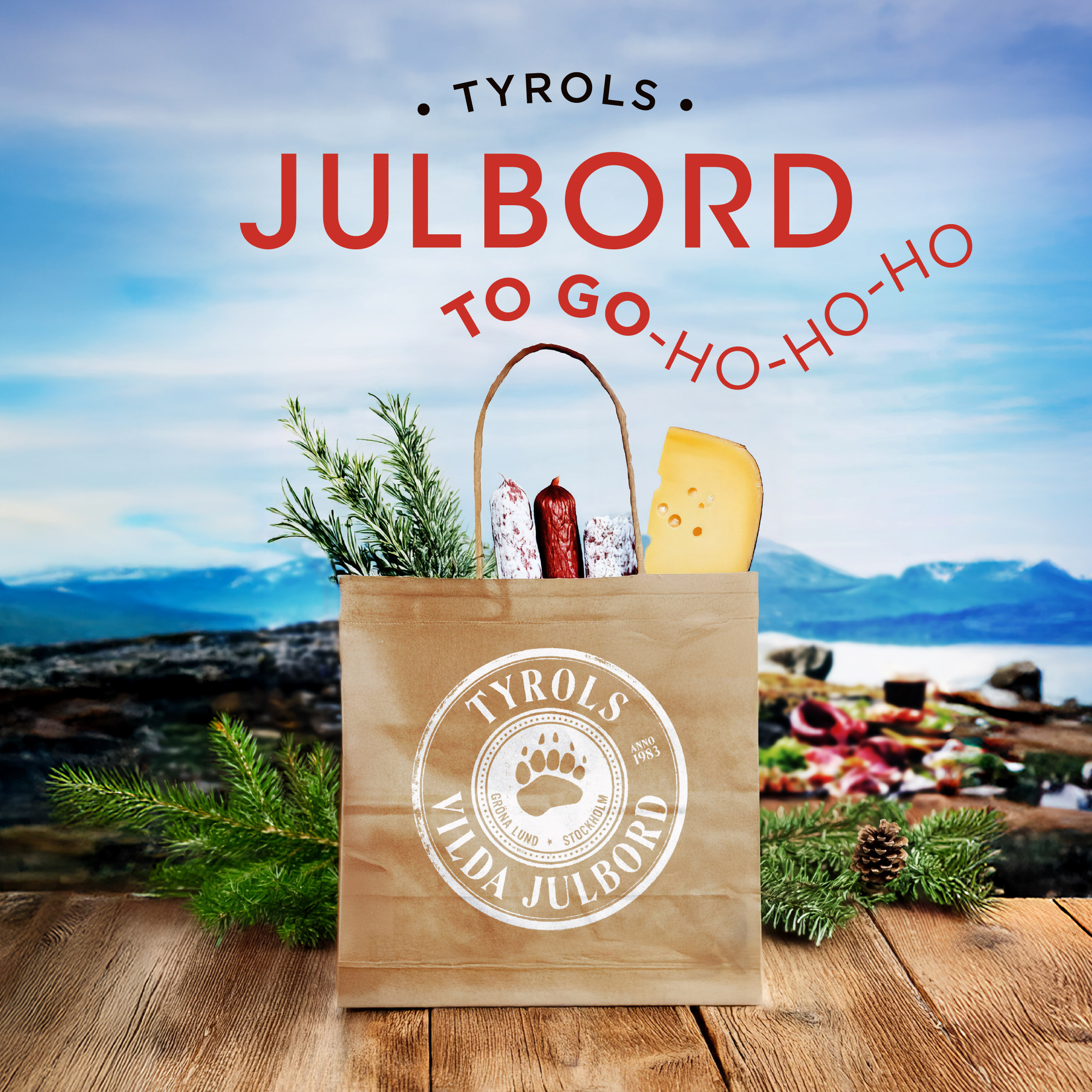 A paper bag labeled "Tyrols Vilda Julbord" contains cheese, sausage, and herbs with a holiday picnic background and the text "Julbord to go-ho-ho-ho.
