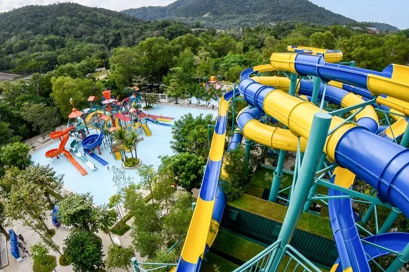 Rides and slides of the ESCAPE Penang theme park amidst the lush forest.