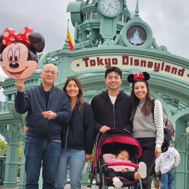 A family with a small kid enjoying a carousel ride at Tokyo Disneyland-pelago