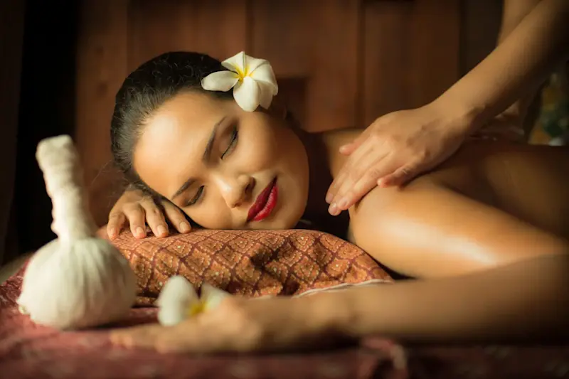 a woman having a back massage in a spa