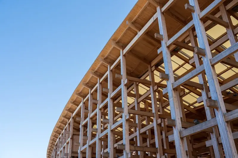Close-up view of the Grand Roof (Ooyane) structure at Expo 2025 Osaka, showing its intricate wooden lattice framework under a clear blue sky.