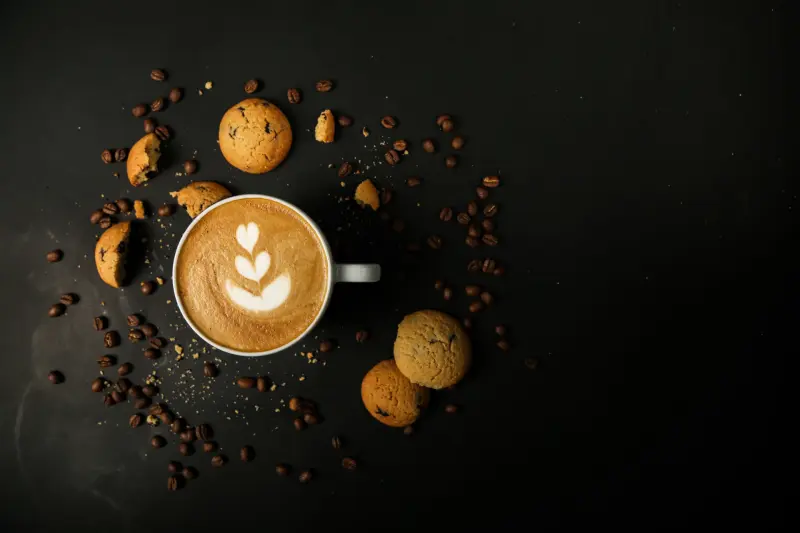 coffee latte cookies beans foam milk top view