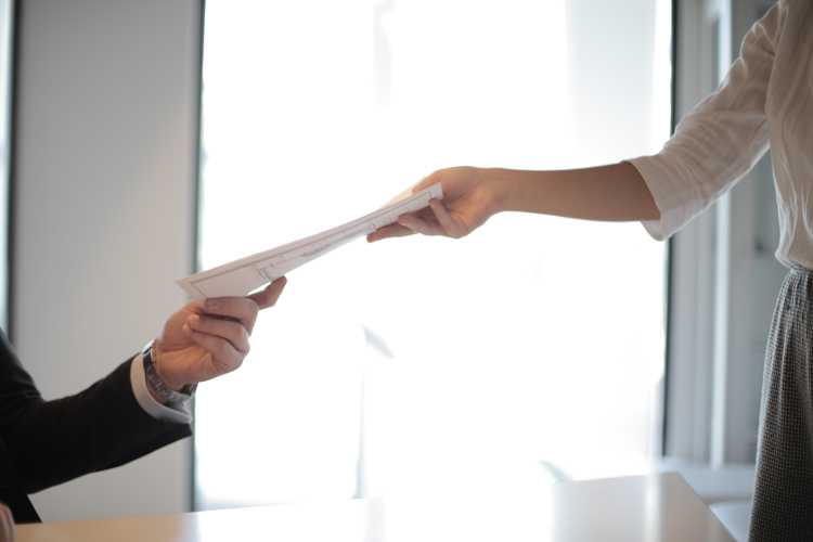 woman hands over file