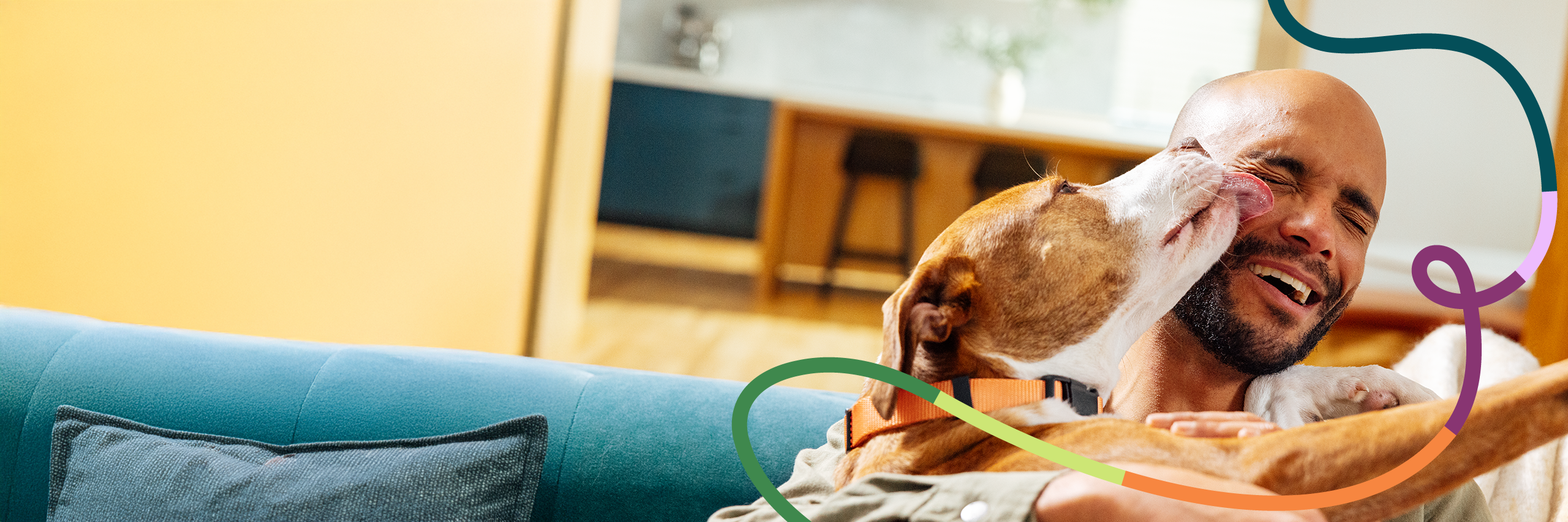 A dog is licking a man's face.