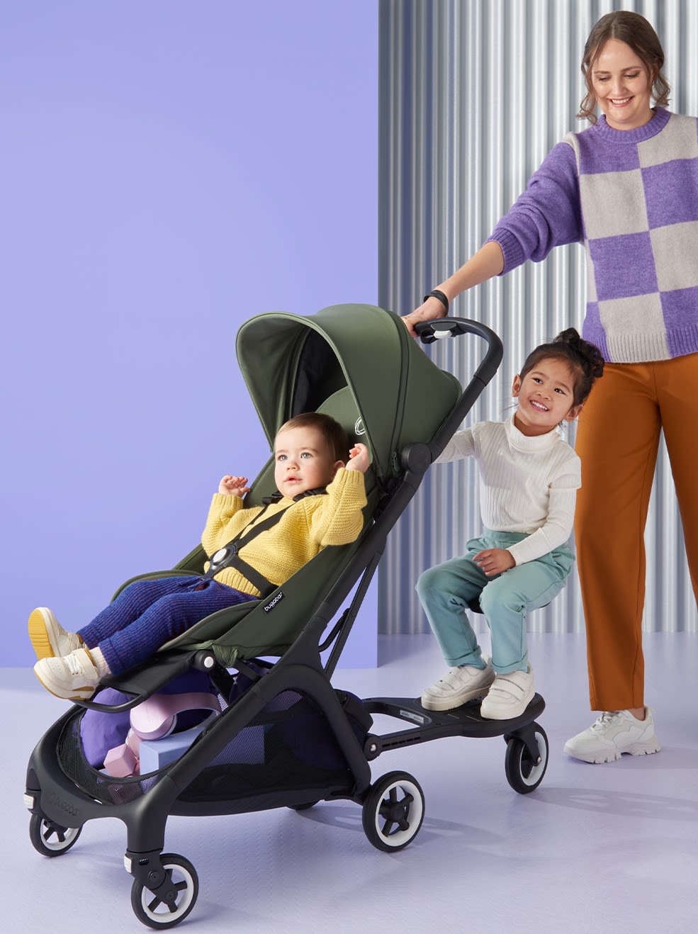 Two small kids with their mother and a butterfly stroller from Bugaboo