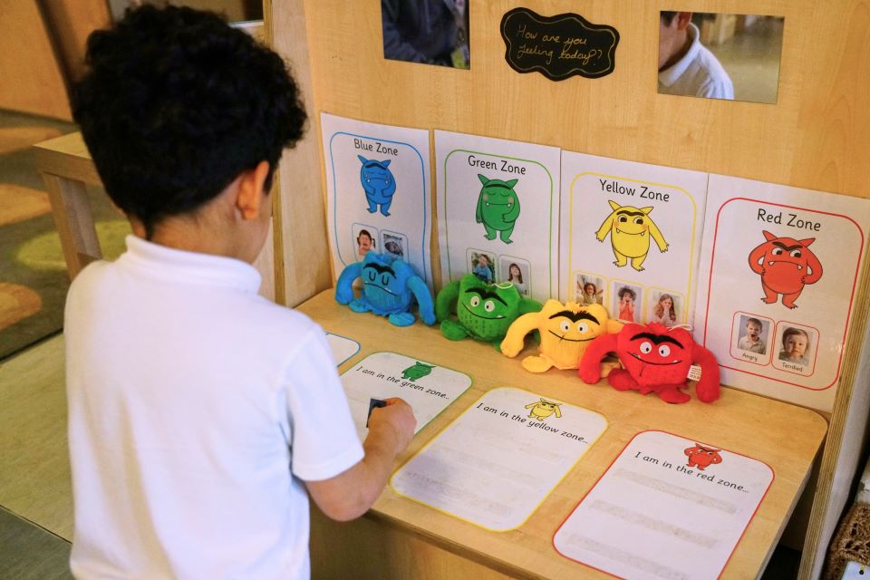 Images/Child looking at a feeling chart