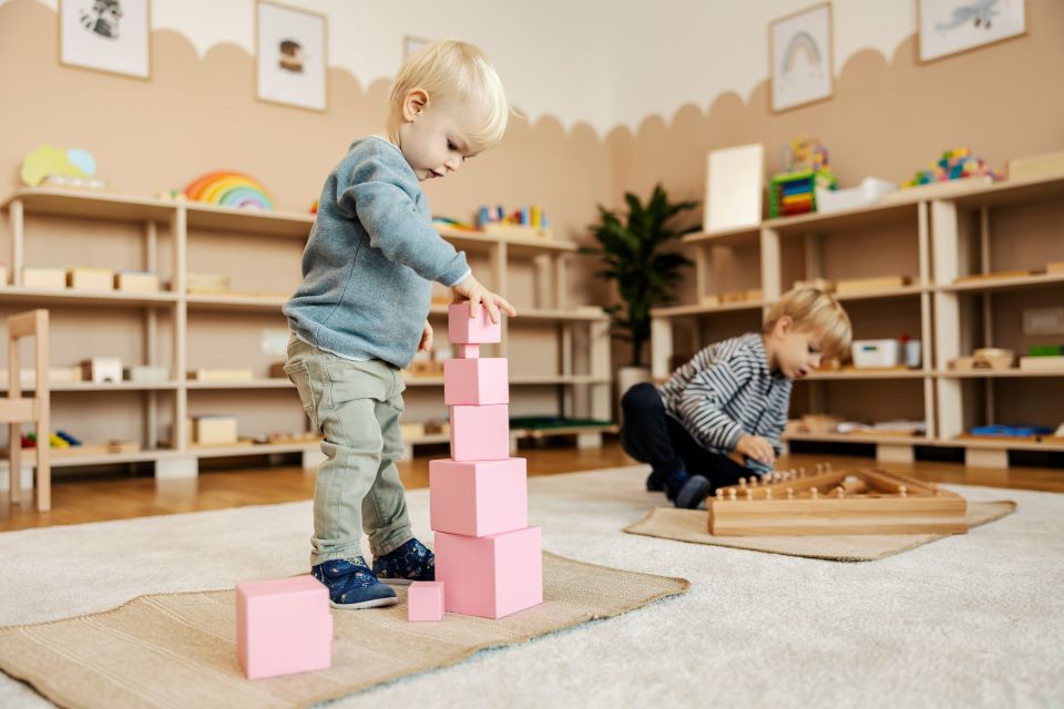 Children at nursery playing games with wooden toys