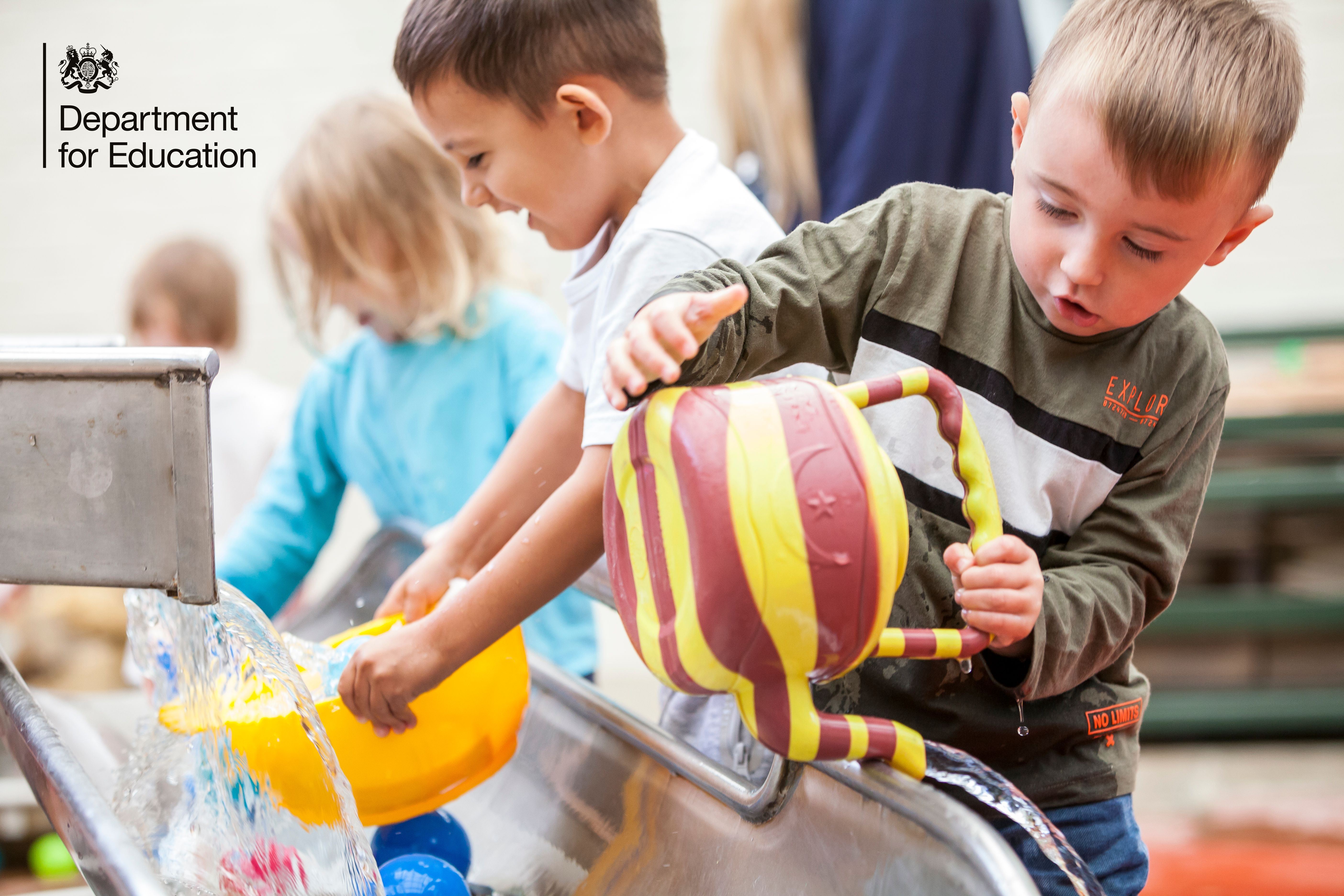 Children playing with toys in a water tray