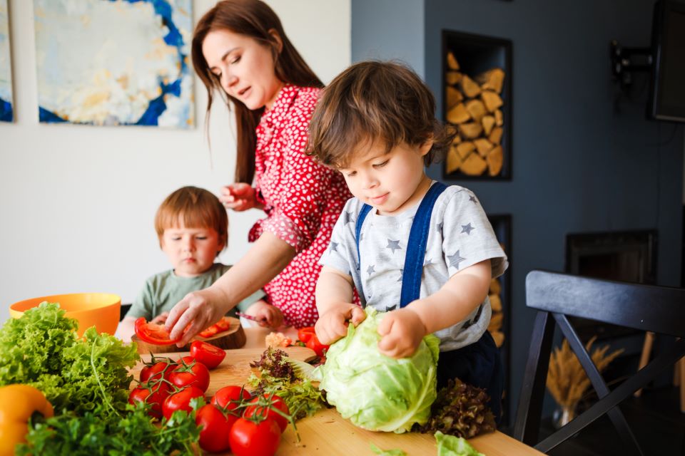 Grown up and children preparing food. 