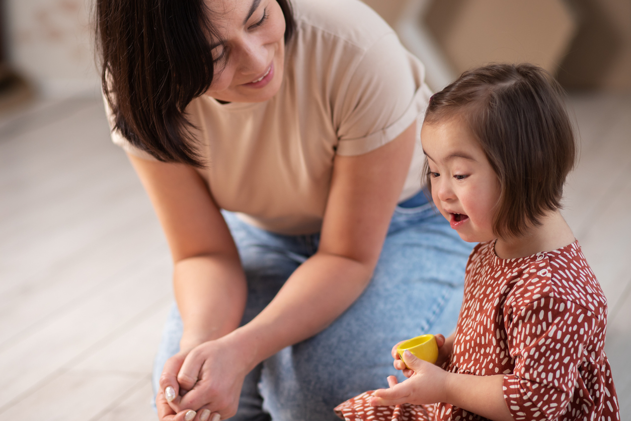 key person talking to and listening to small child.