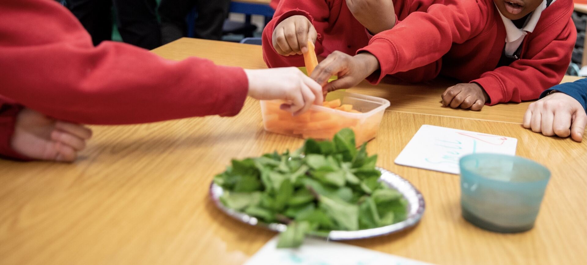 Children trying carrot sticks