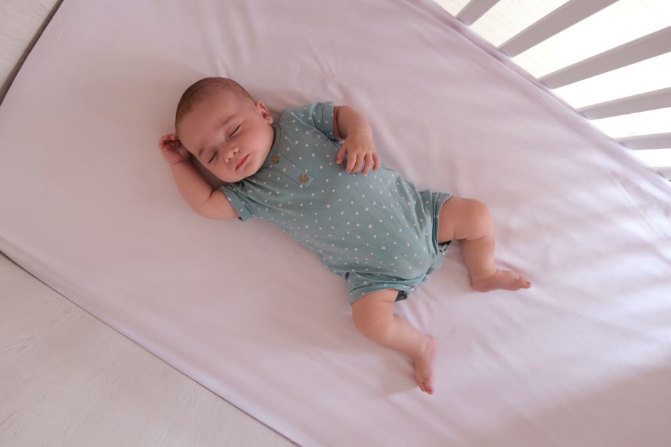 Baby sleeping in cot