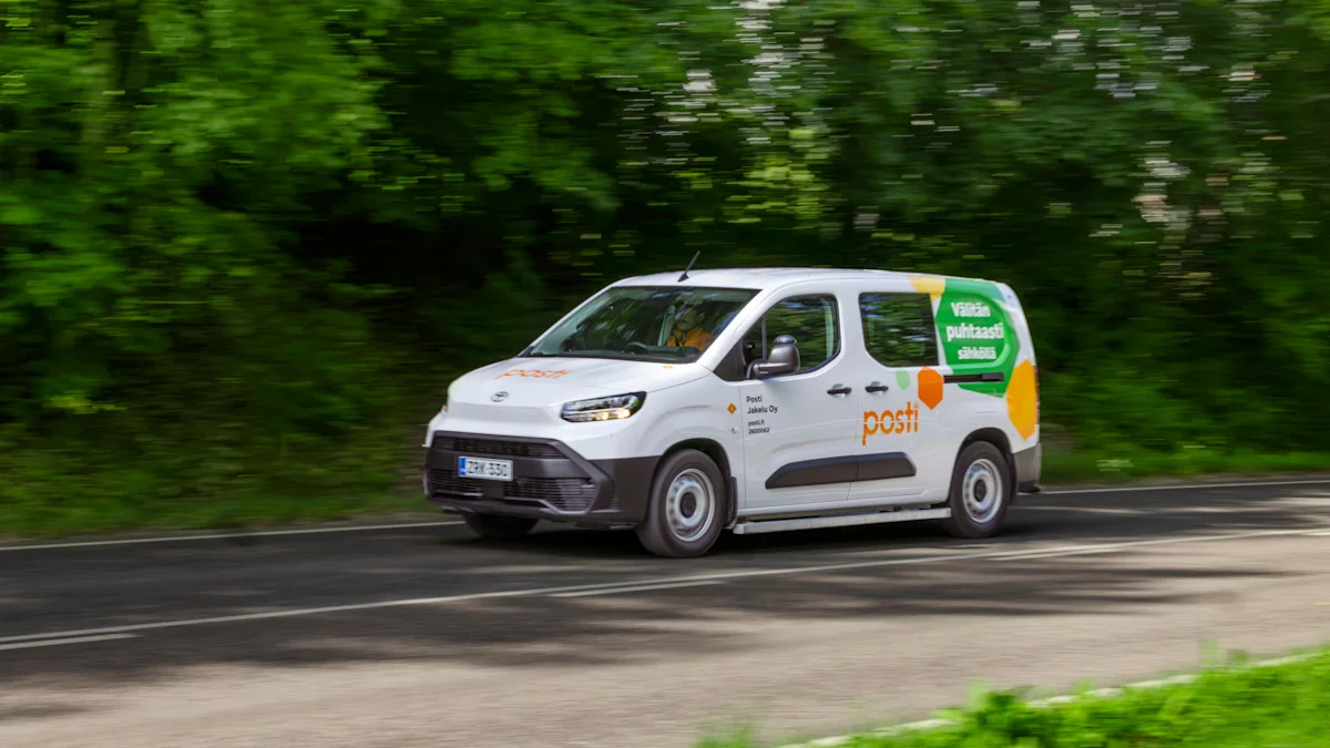 Posti delivery van driving on a road past trees