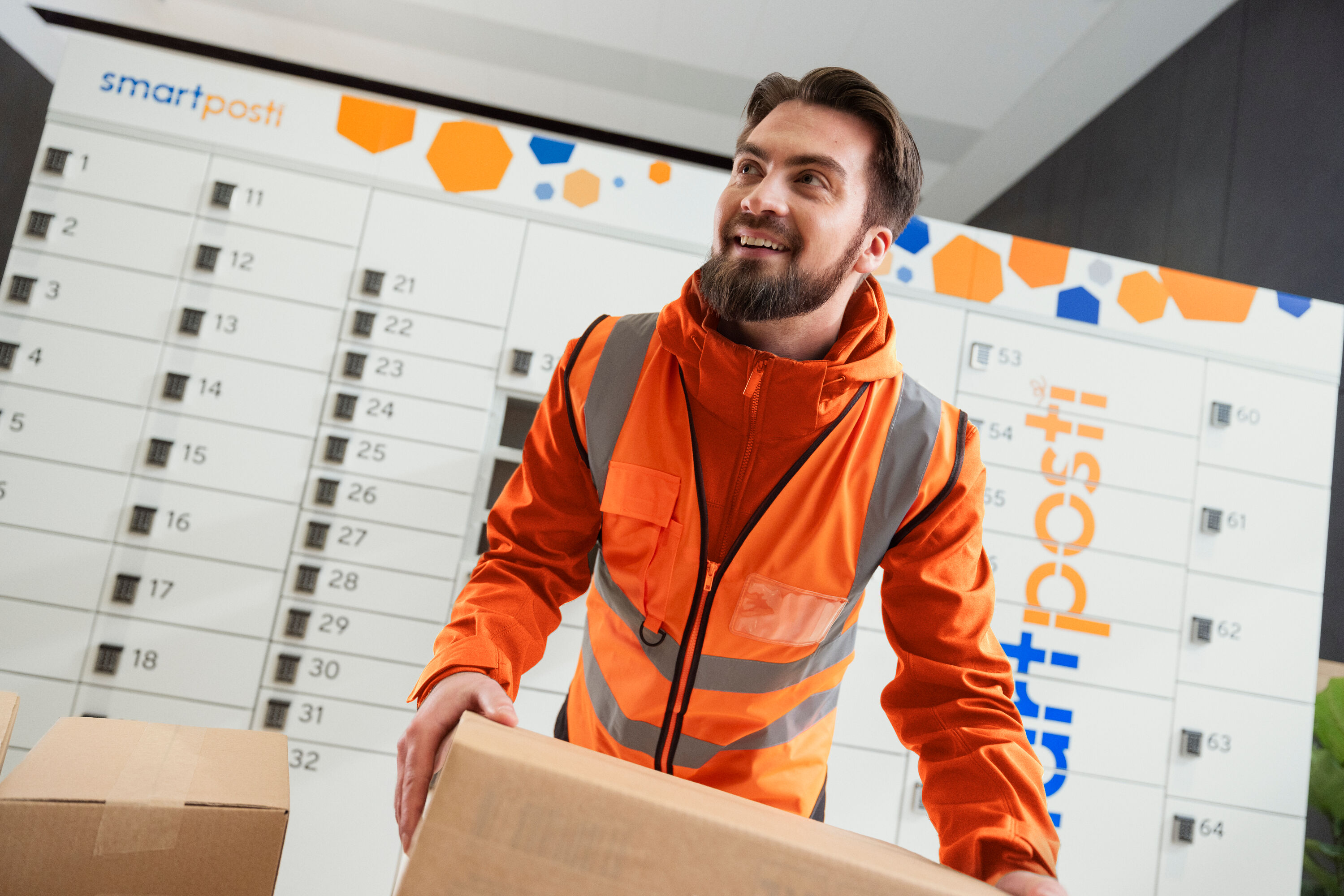 A SmartPosti worker carrying a package.