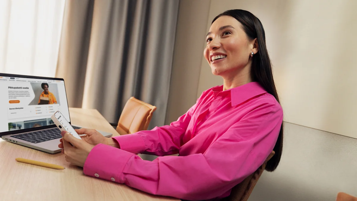 A person is sitting at a desk, looking at a laptop screen and holding a phone. They are wearing a bright pink shirt. The screen shows Posti's online store with product images.