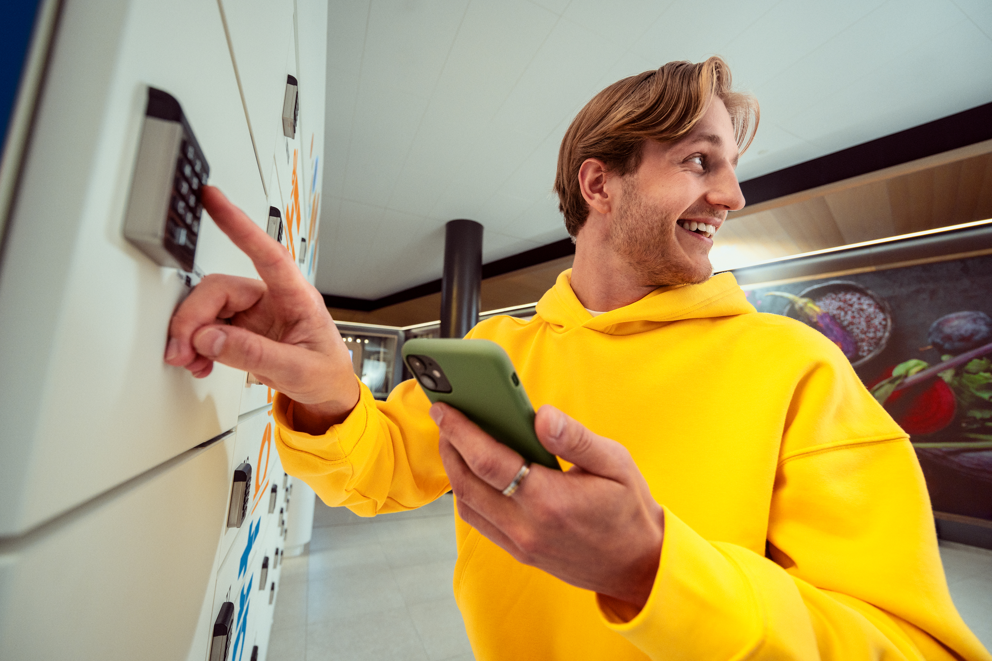 A smiling customer at a SmartPosti locker.