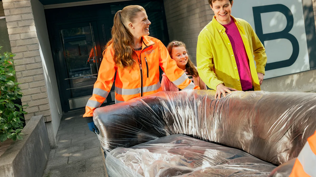Posti employees pick up a protected sofa from a customer’s home for storage in Posti Remote Home Storage.
