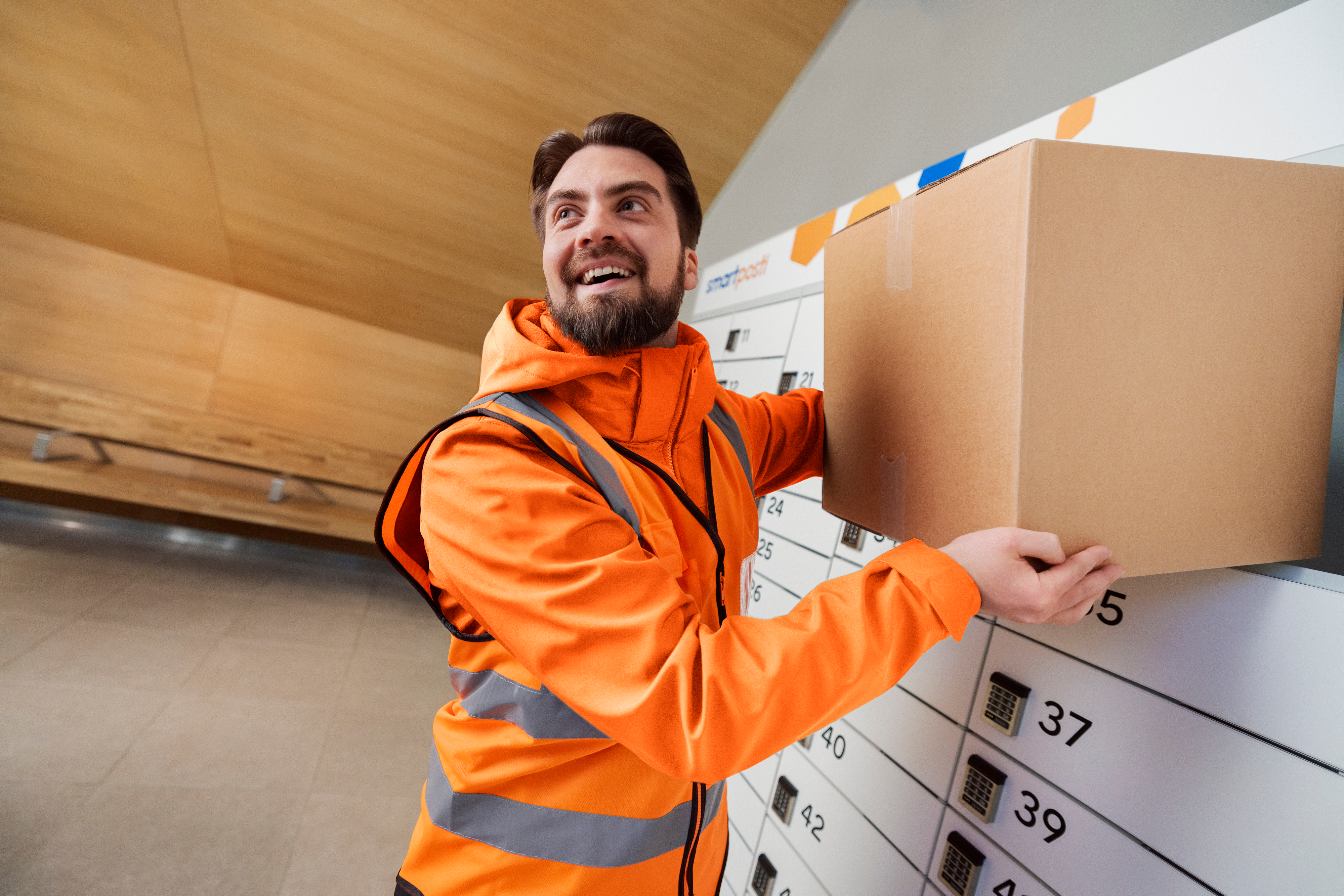 A man taking a parcel from parcel locker.