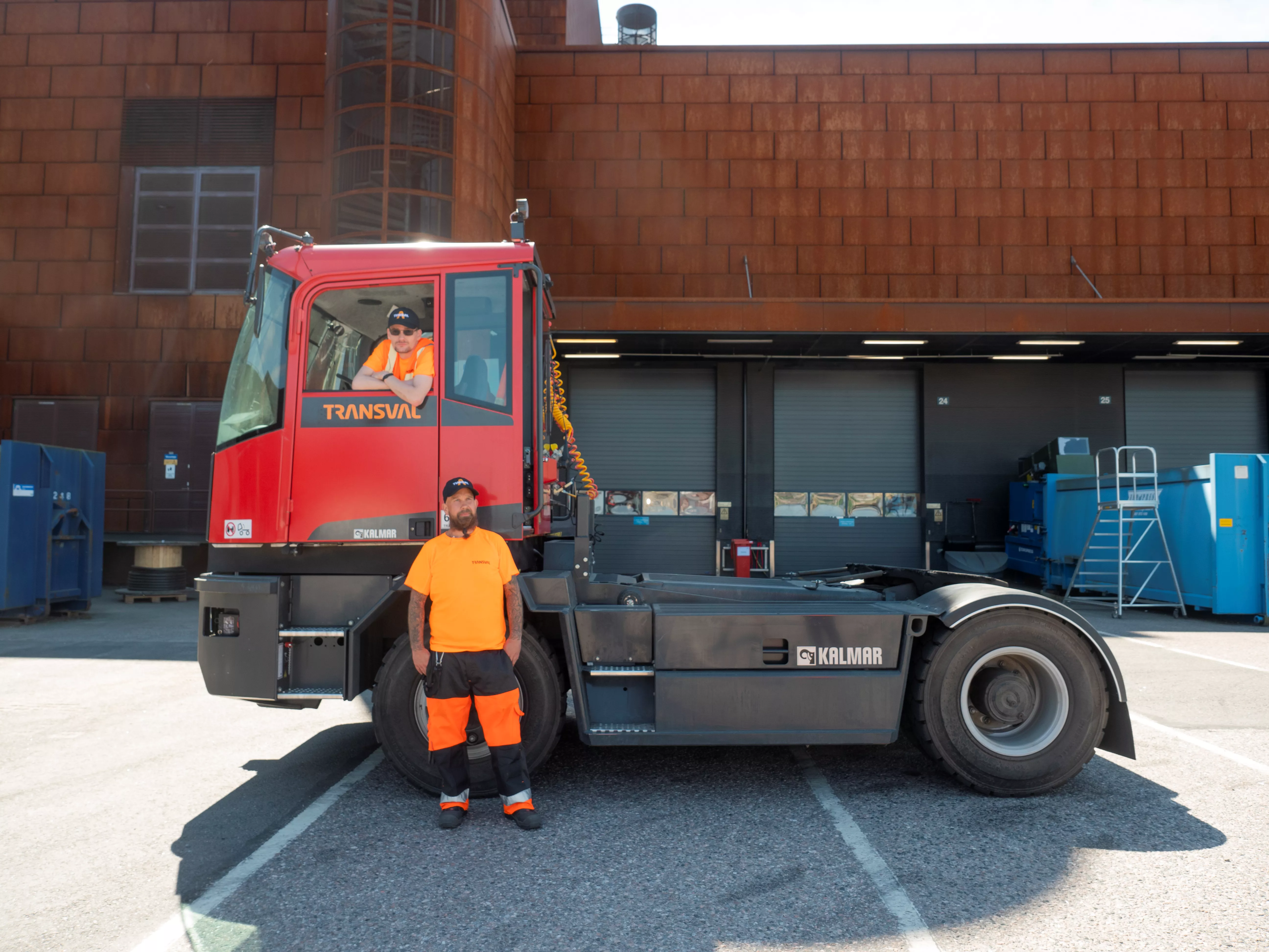 Two of Transval’s Logistics personnel next to transportation vehicle.