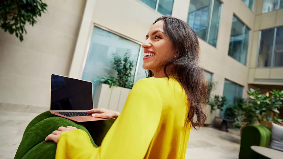A smiling woman and a laptop.
