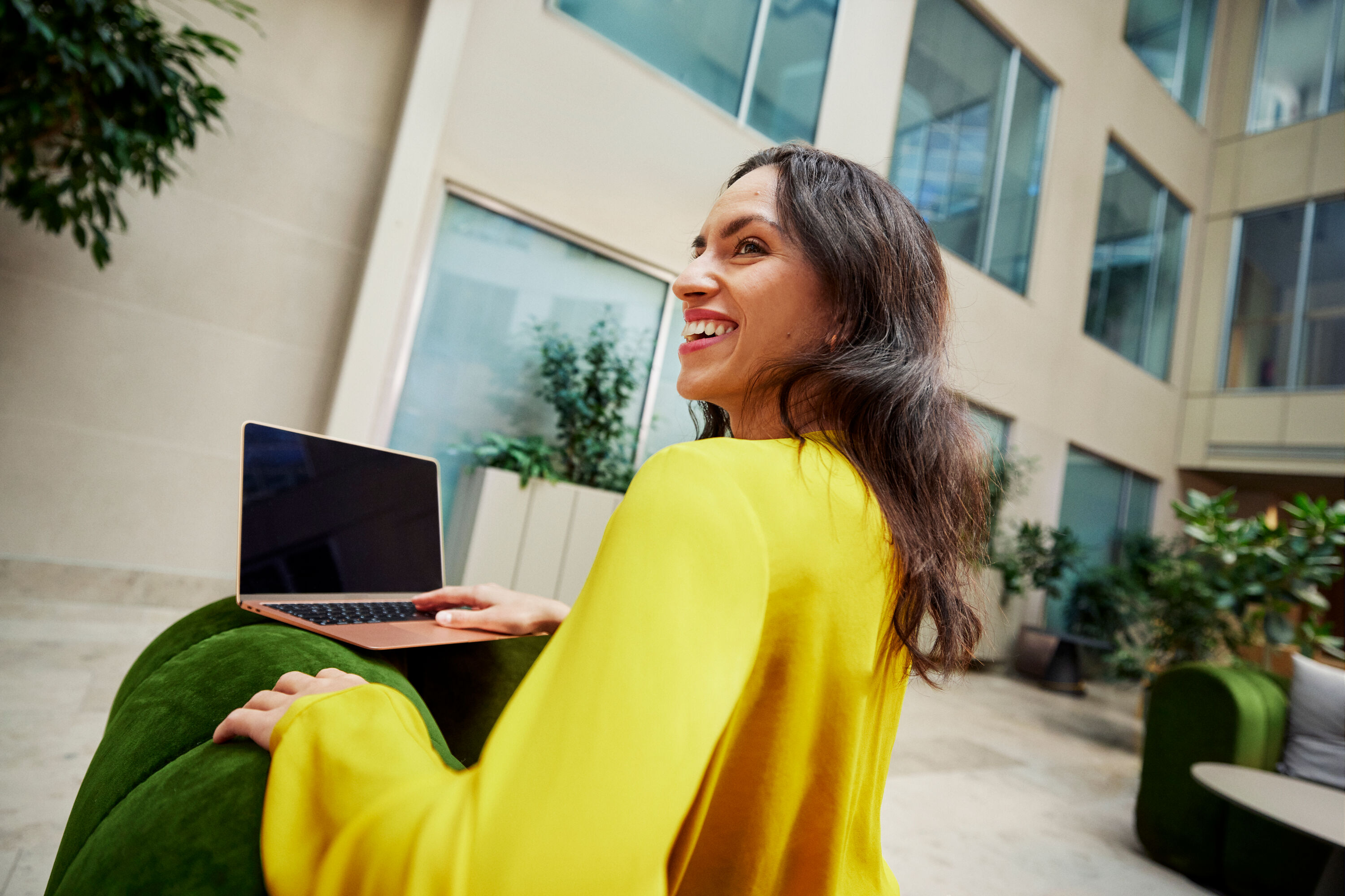 A smiling woman and a laptop.