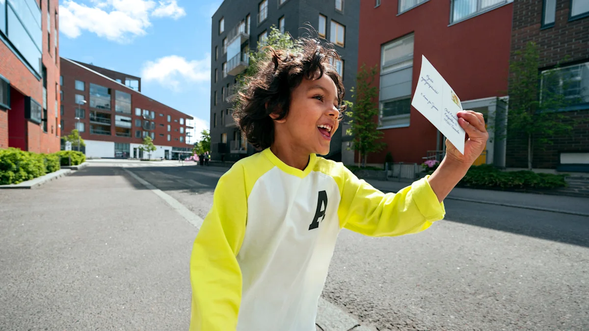 a smiling child holding a postcard.