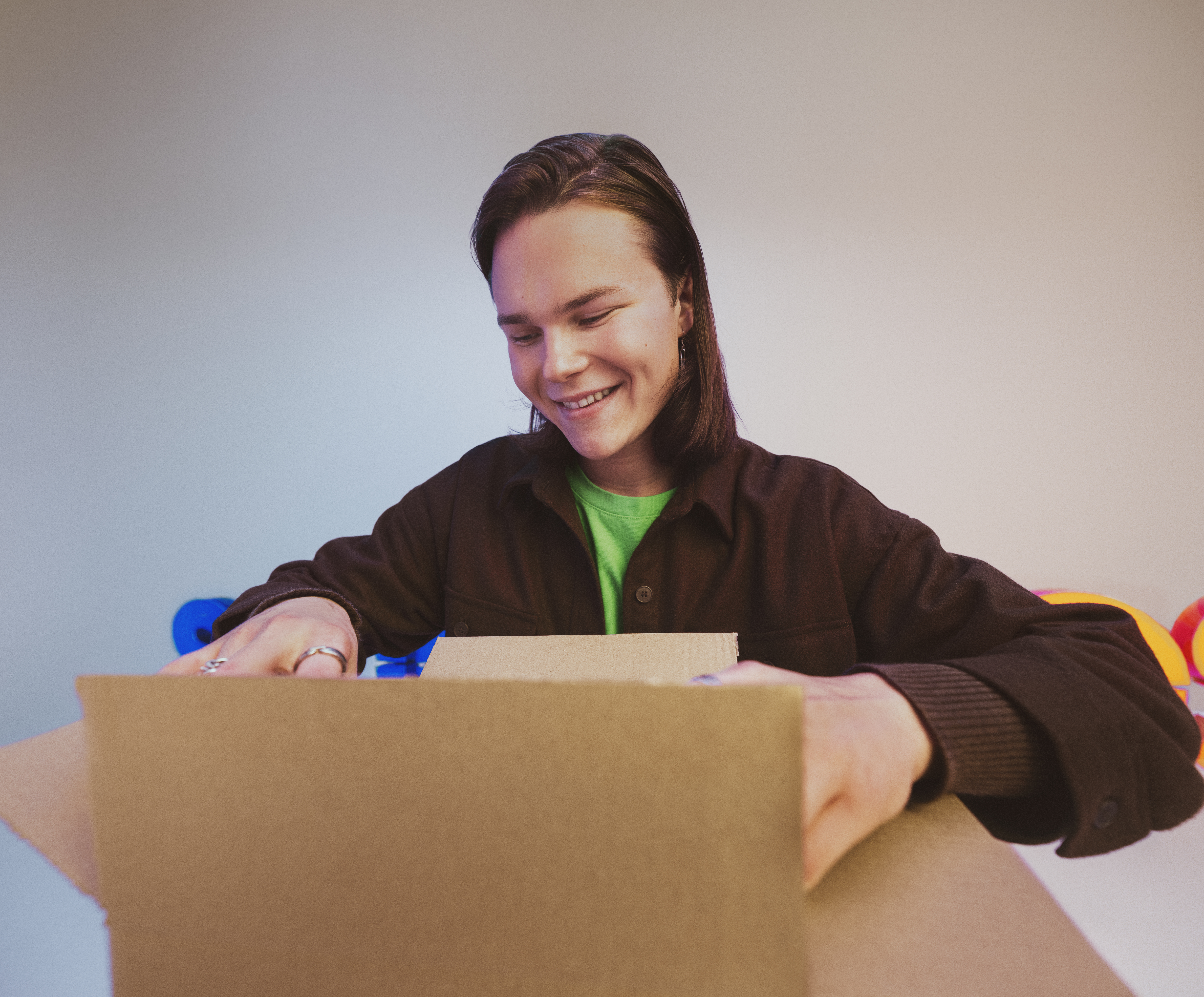A woman looking into a cardboard box.