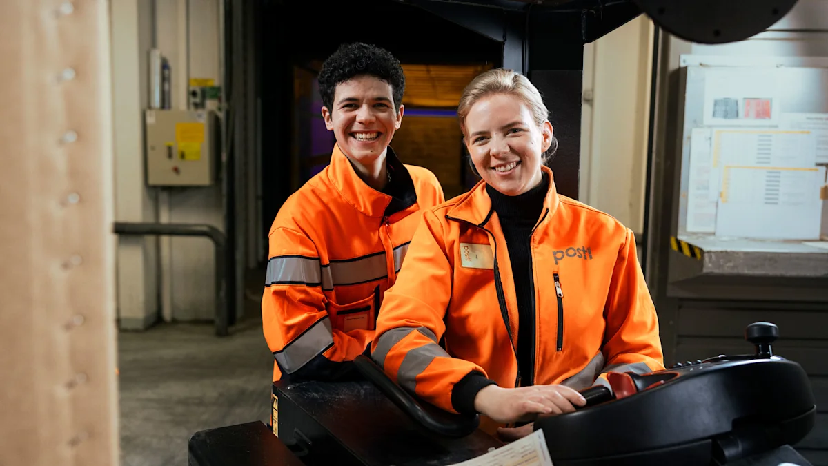 Two Posti employees smiling and working