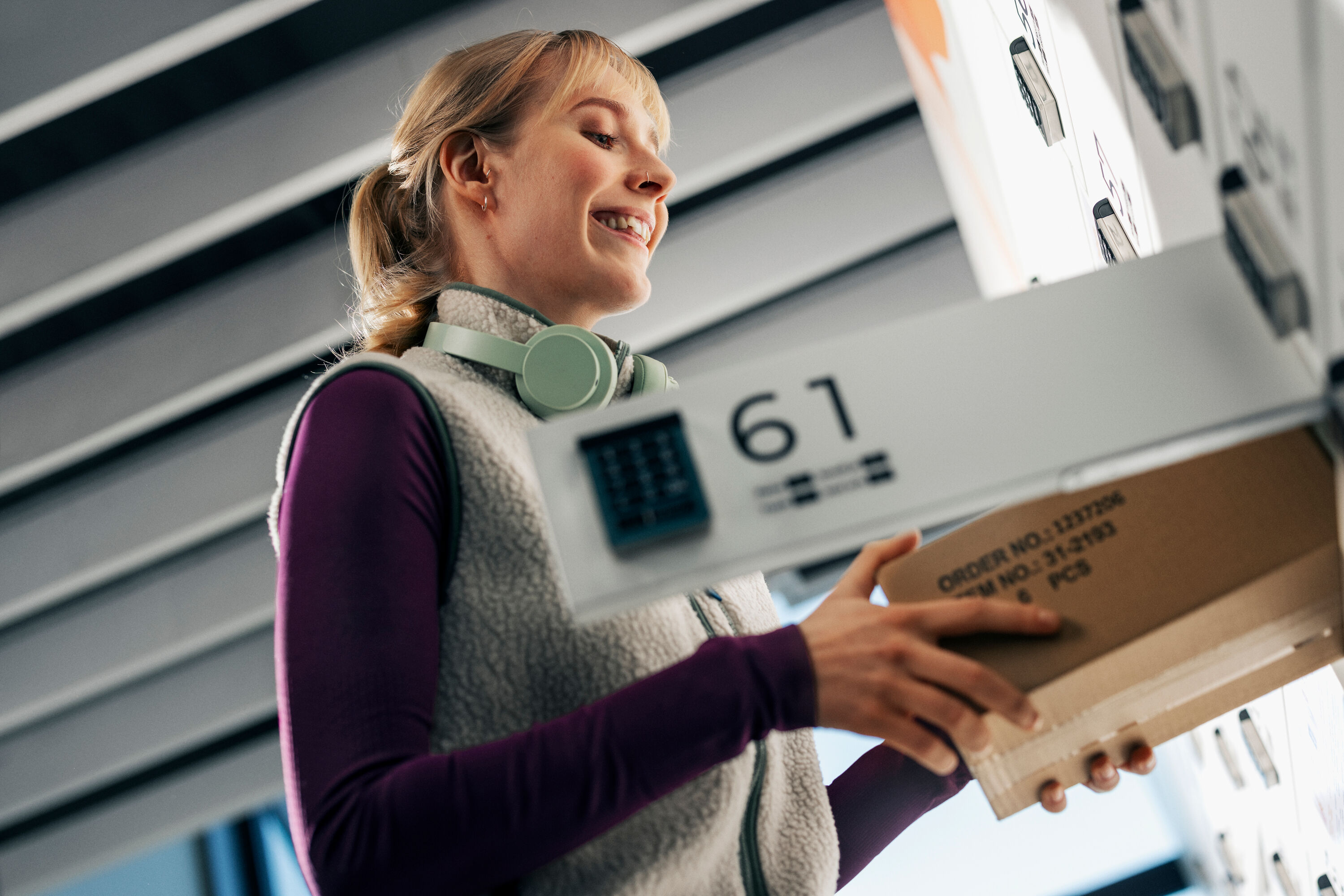 A woman picking up a package.