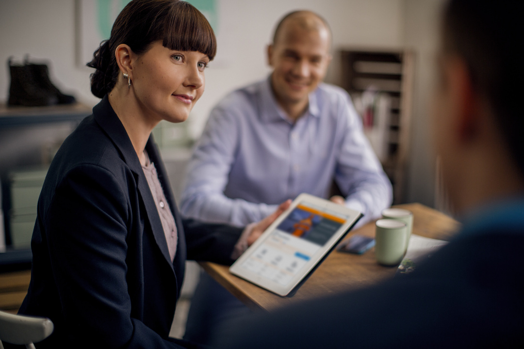 A smiling SmartPosti employee in a meeting.