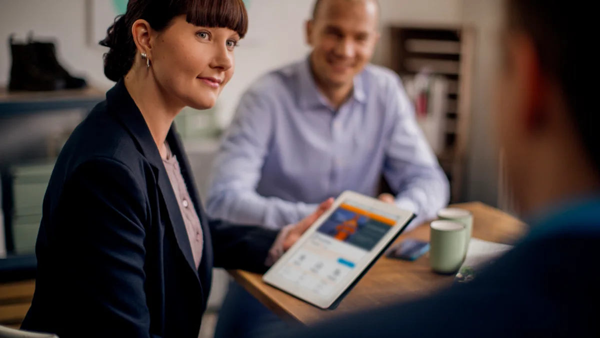A smiling SmartPosti employee in a meeting.