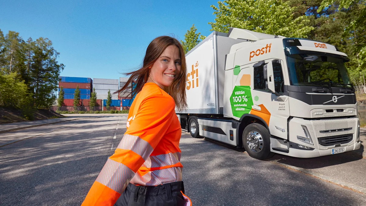 A smiling woman and a postal truck.